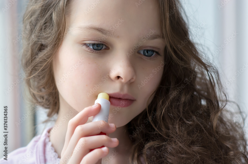 Portrait of beautiful little girl applying lipbalm. Portrait of beautiful little girl applying lipbalm.