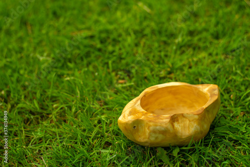 Wooden mug of suvela birch on a green grass photo