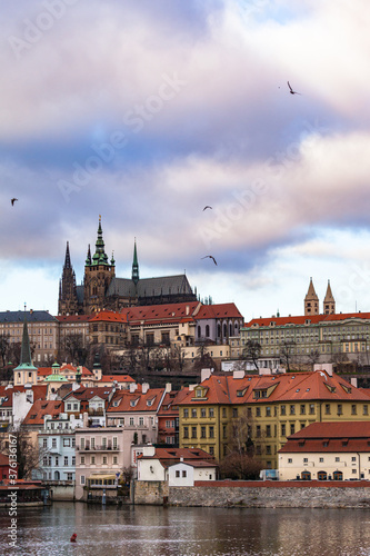 Beautiful view of Prague Castle and St. Vitus Cathedral located in Mala Strana old district on the Vltava river side of Prague on winter day with blue sky cloud, Czech Republic