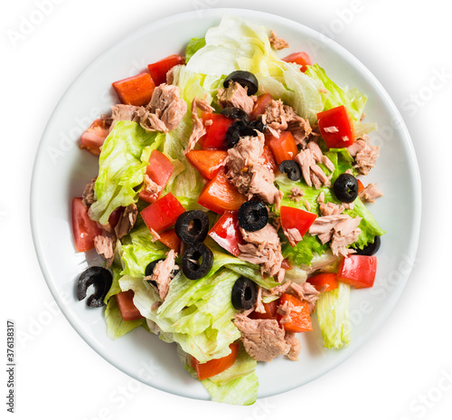 Tuna salad with tomatoes, black olives, and greens isolated in white background. Top view