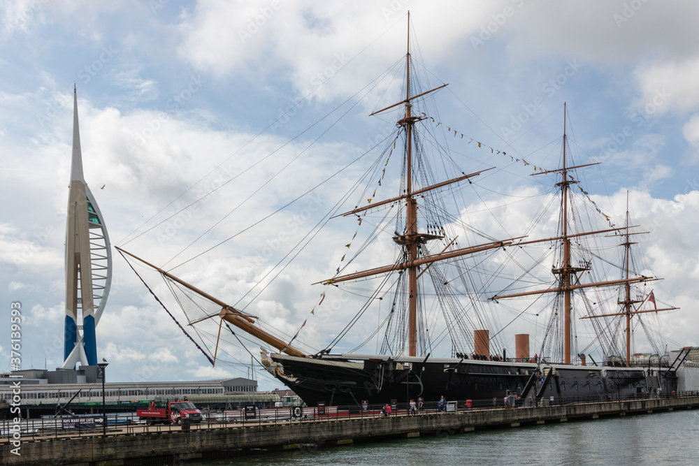 The Spinnaker Tower and HMS warrior side by side in Portsmouth Dockyard The Spinnaker Tower and HMS warrior side by side in Portsmouth Dockyard