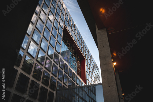 Upwards angle look up shot of big modern building with sky reflection on the windows