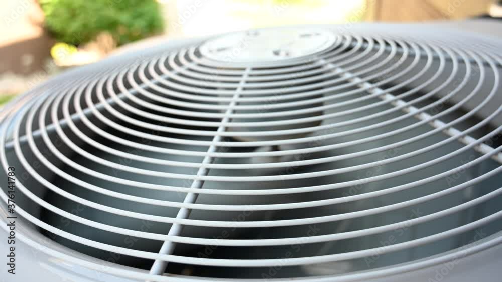 Startup of a residential air conditioner unit.  Fan blades are stopped at the beginning and then accelerate to full speed.  