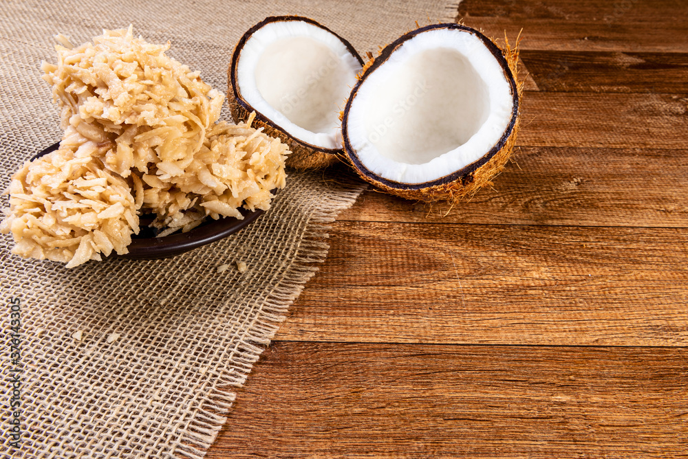 Cocada on the wooden table. Traditional coconut sweet from Brazil.