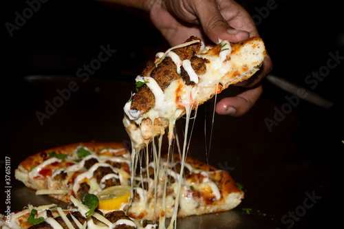Pizza slice in hand