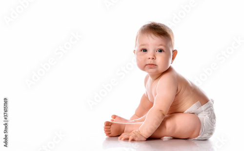 baby sitting on floor over white copyspace