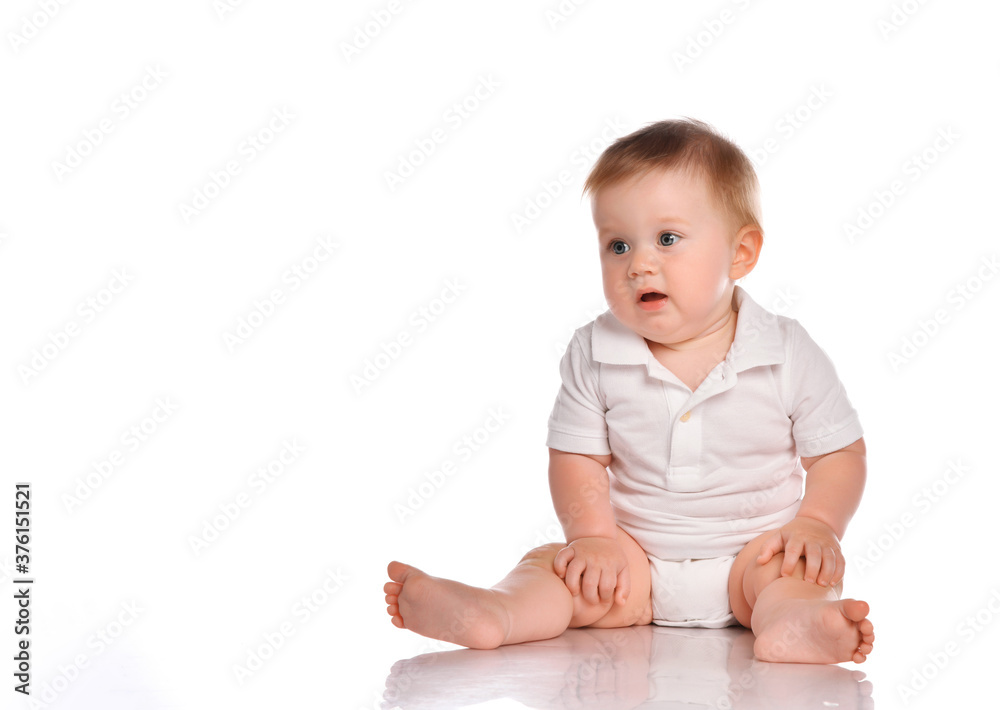 Cute little boy in white bodysuit sitting isolated on white Cute little boy in white bodysuit sitting isolated on white