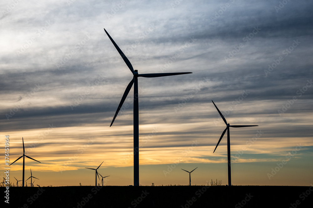 Sunset behind a field of wind turbines Sunset behind a field of wind turbines