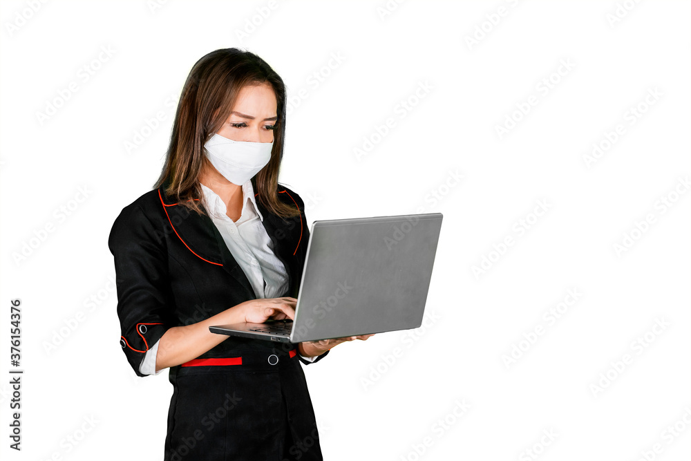 Female manager wear mask while use laptop on studio Female manager wear mask while use laptop on studio