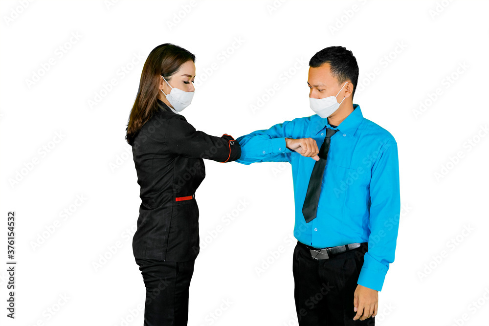 Two business people greeting with elbows on studio Two business people greeting with elbows on studio