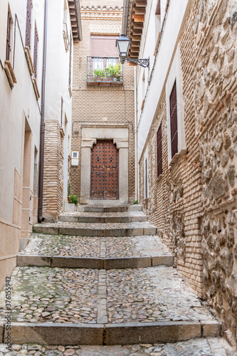 Fototapeta Naklejka Na Ścianę i Meble -  In Toledo, Spain, beautiful architecture of stone stairs along the back streets  of the charming old city.
