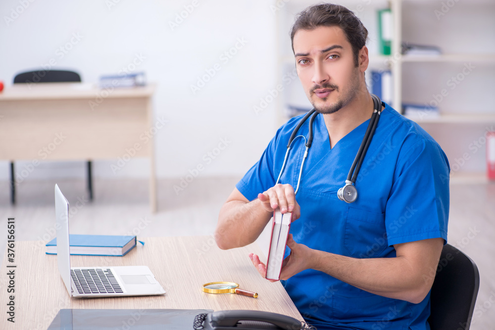 Young male doctor working in the clinic Young male doctor working in the clinic