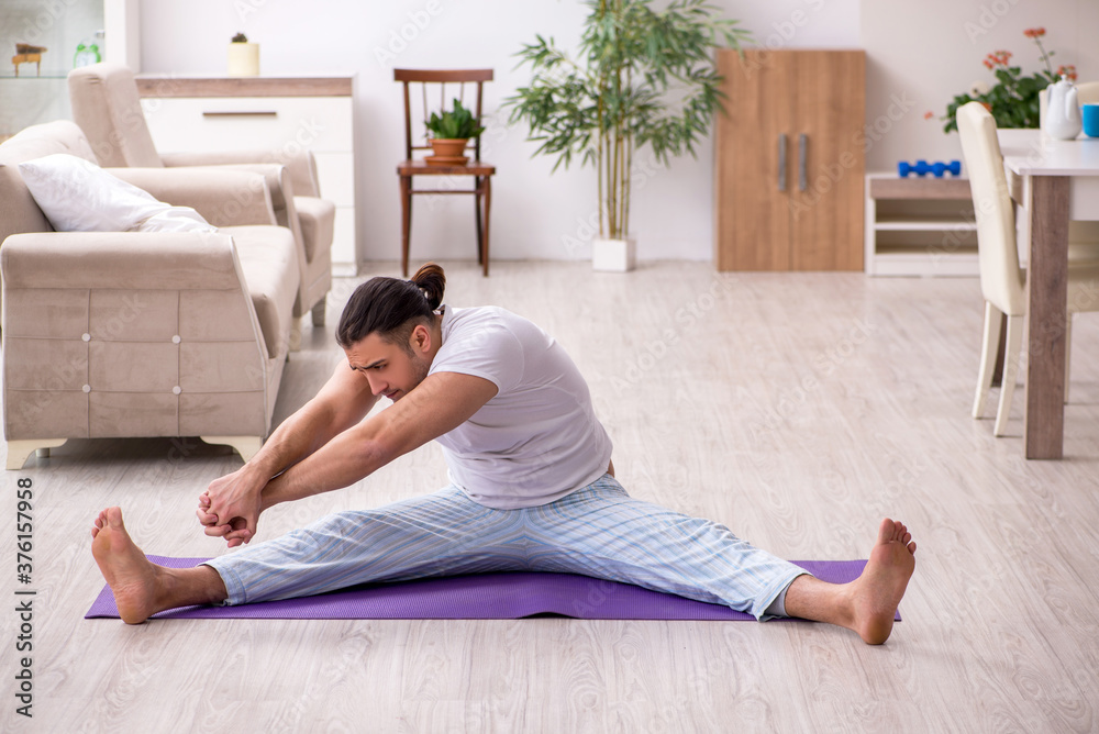 Young male starting day with morning exercises Young male starting day with morning exercises
