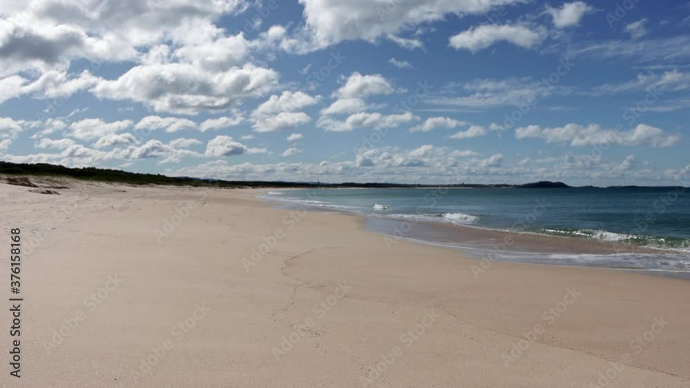 Huskisson Beach at Jervis Bay in Australia with calm waves and clouds rolling, Locked shot Huskisson Beach at Jervis Bay in Australia with calm waves and clouds rolling, Locked shot