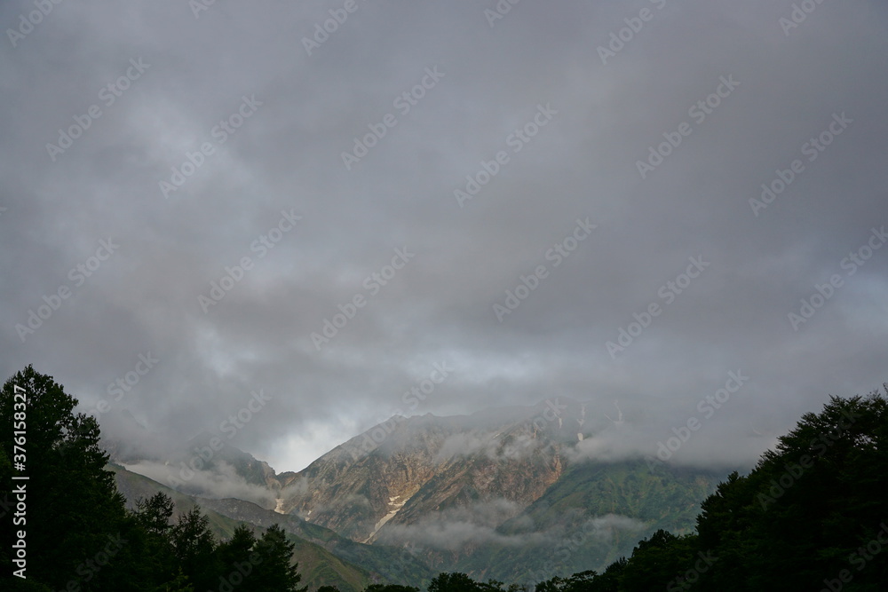 Mountain valley cloudy sky landscape. Mountain valley view. Japanese alps, Hakuba, Japan　
