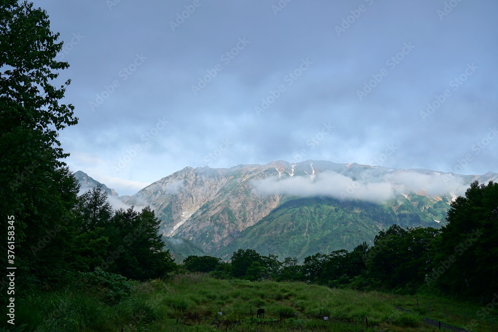 Mountain valley cloudy sky landscape. Mountain valley view. Japanese alps, Hakuba, Japan　