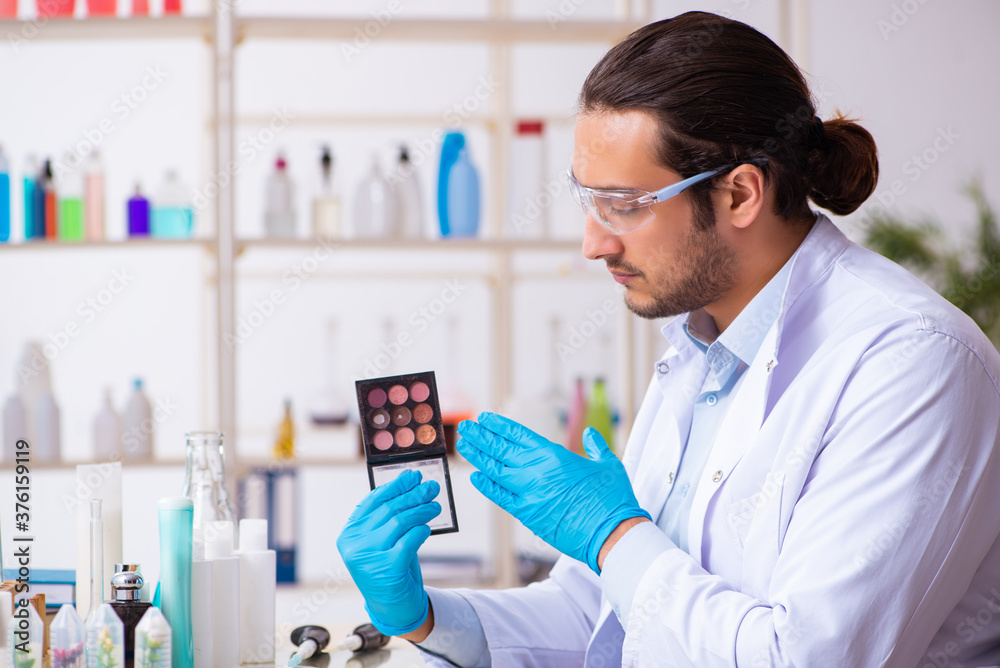 Young male chemist working in the lab Young male chemist working in the lab
