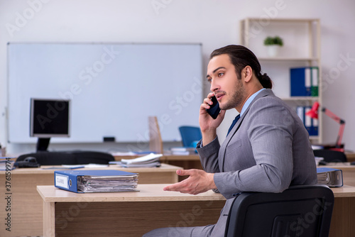 Young male businessman employee working in the office