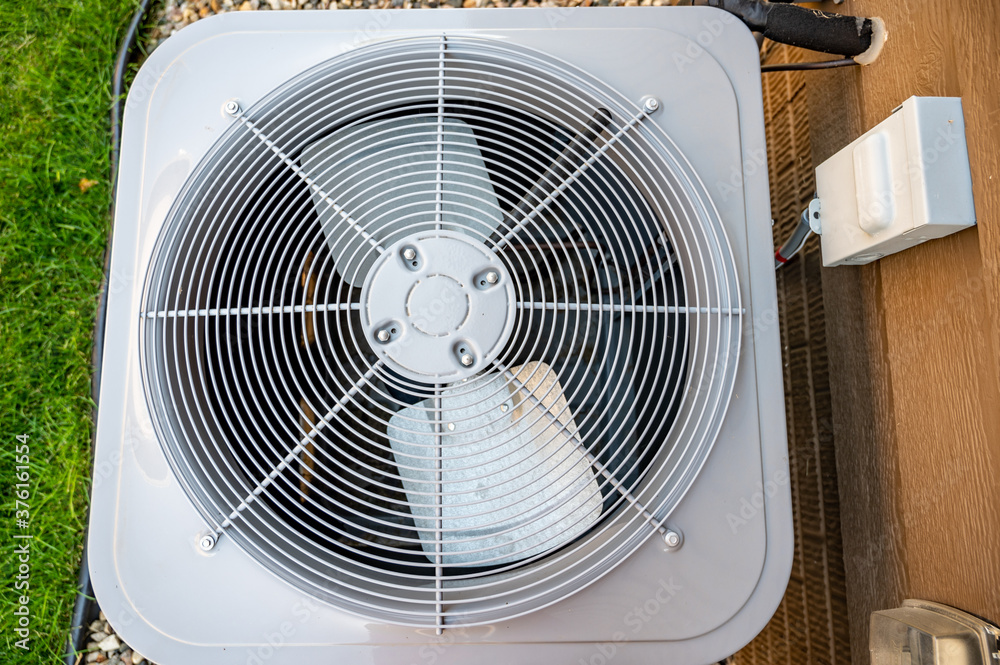Top view of Residential air conditioning unit outdoors with fan and coils Top view of Residential air conditioning unit outdoors with fan and coils