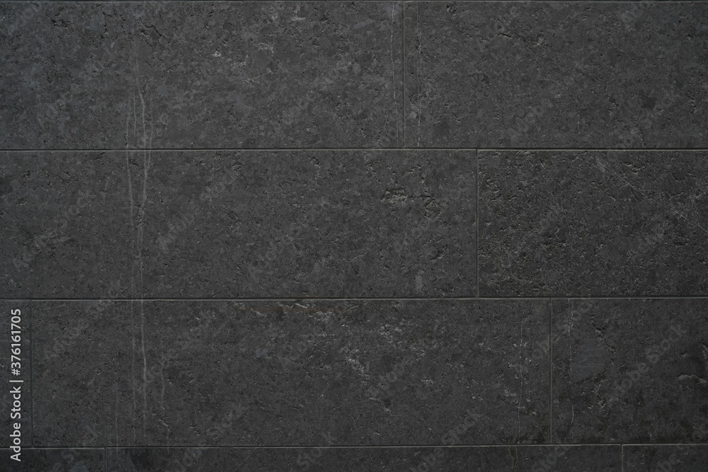 Fototapeta premium Dark Black Stone Texture in outdoor exterior with repeating pattern texture with dark black colour