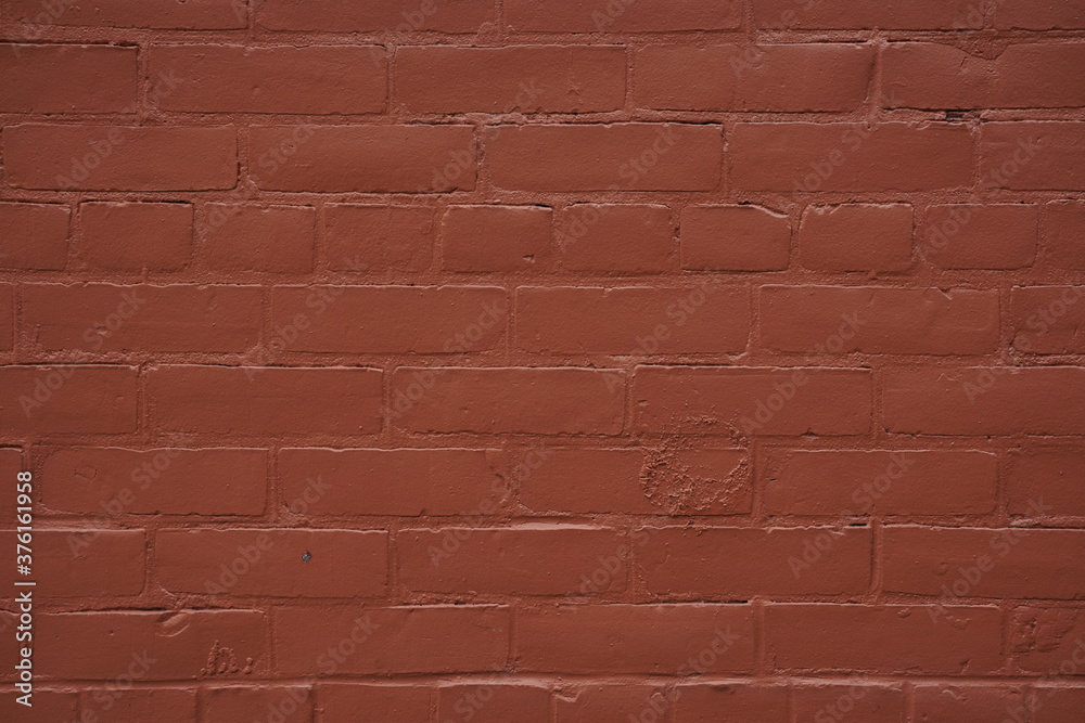 Fototapeta premium red brick wall background with a brick pattern and red-colored smooth texture
