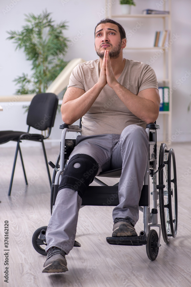 Fototapeta premium Young leg injured man in wheel-chair