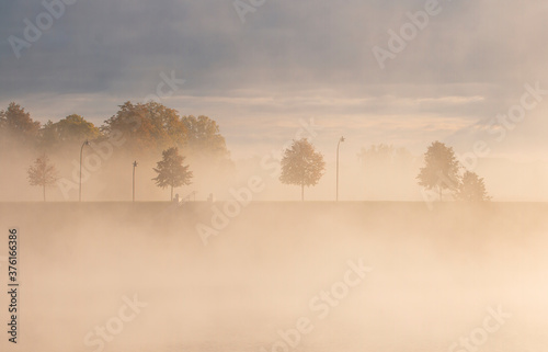 city autumn landscape, promenade covered with autumn fog