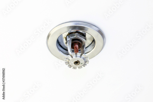 Close-up ceiling mounted fire sprinkler in the building concepts of fire alarm prevention and safety system.