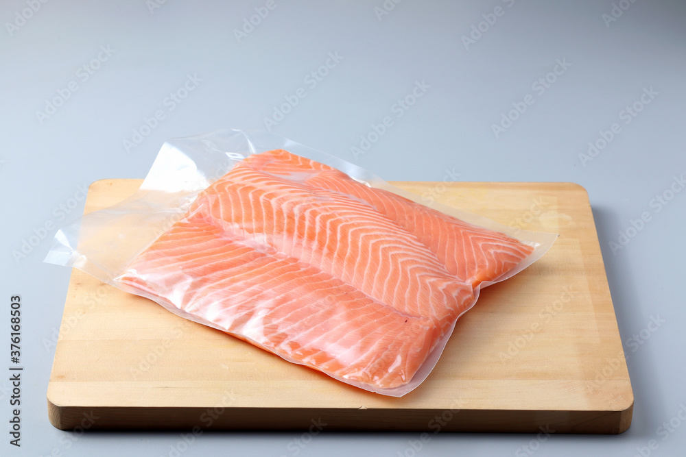Salmon fillets in a vacuum package. Sous-vide, new technology cuisine. Selective focus, copy space