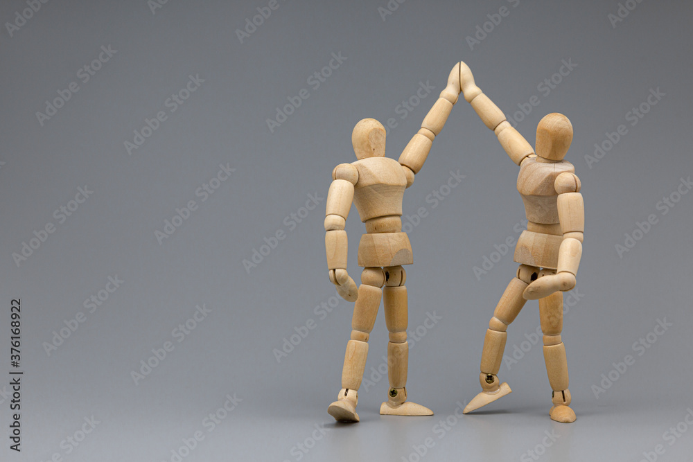 Wooden figure businessman pleasure and congratulate with team. Wooden figure businessman pleasure and congratulate with team.