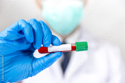 Doctor holding virus blood test tube