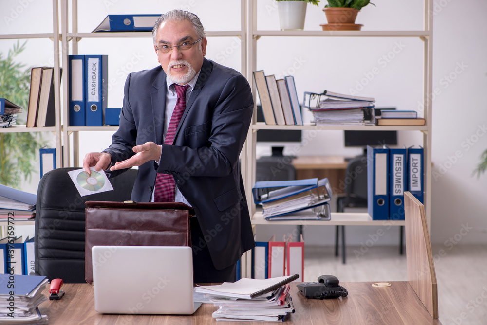 Old male employee unhappy with excessive work Old male employee unhappy with excessive work