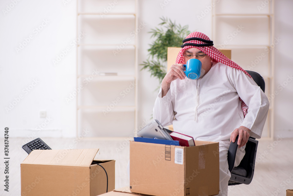 Old arab businessman in office relocation concept Old arab businessman in office relocation concept