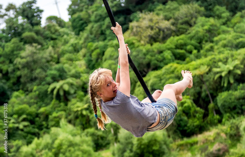 Girl Swinging On A Tree Swing With Bushland In The Back Ground