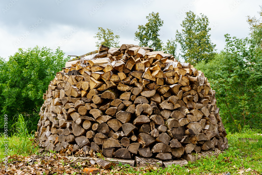 Round woodpile of the original design for cold winter in Russia