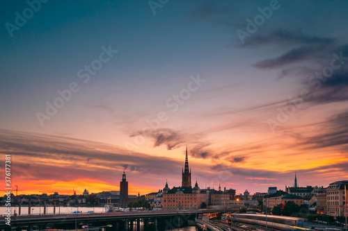 Stockholm, Sweden. Scenic View Of Stockholm Skyline At Summer Evening. Famous Popular Destination Scenic Place Under Dramatic Sky In Sunset Lights. Riddarholm Church, Subway Railway