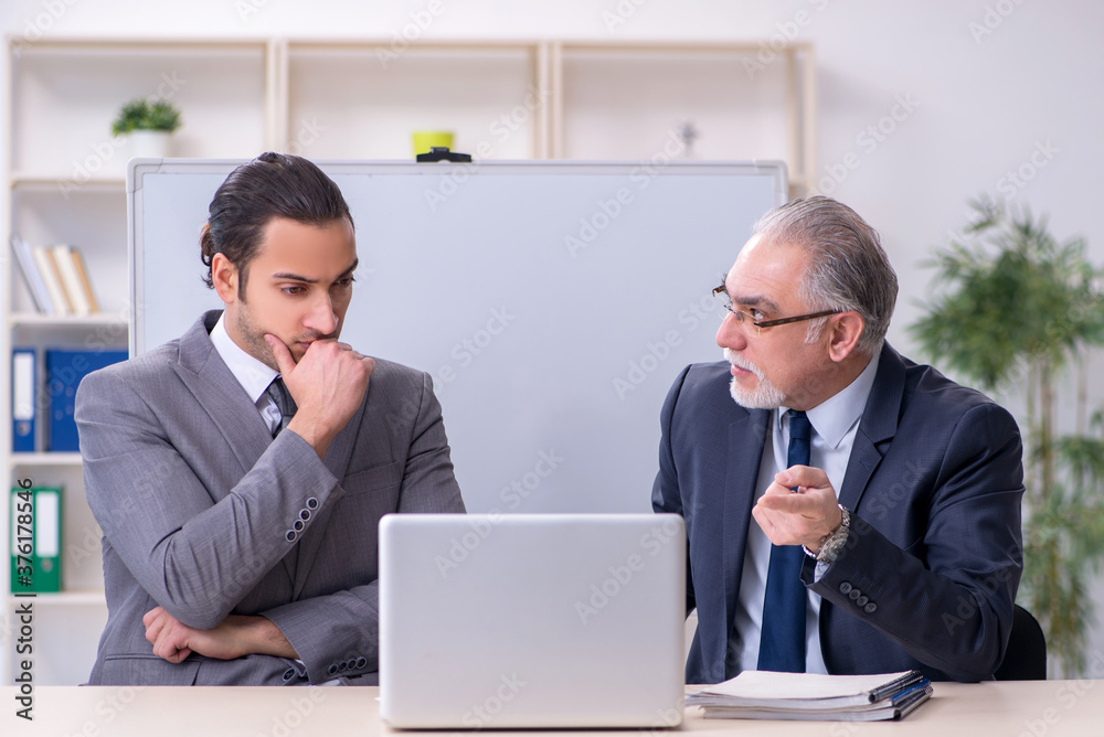 Old and young businessmen in business meeting concept Old and young businessmen in business meeting concept