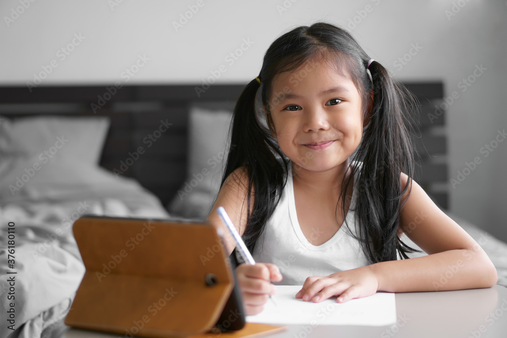 asian child student back to school or kid girl smile write or draw and read on computer tablet with doing homework to new idea think or people learn from home in bedroom and study online on smartphone asian child student back to school or kid girl smile write or draw and read on computer tablet with doing homework to new idea think or people learn from home in bedroom and study online on smartphone