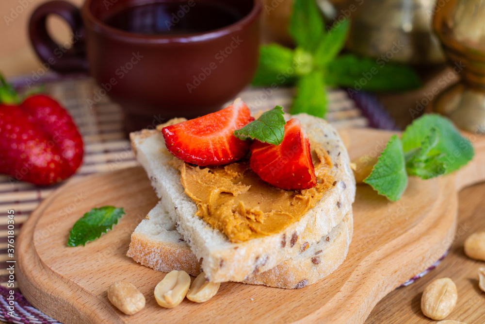 peanut butter wholegrain sandwiches or toasts with strawberries, healthy nutrition concept