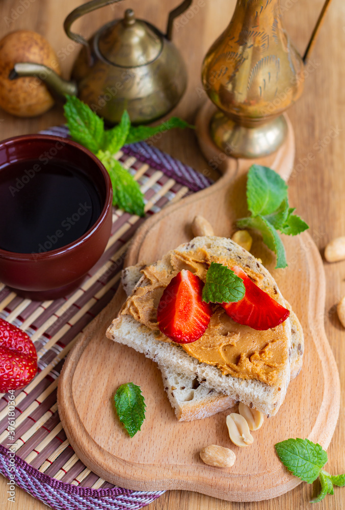 flat lay of peanut butter whole grain sandwich, top view of toast with strawberries, healthy nutrition concept flat lay of peanut butter whole grain sandwich, top view of toast with strawberries, healthy nutrition concept