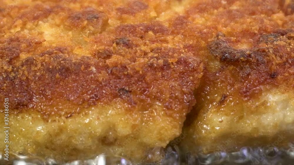 Close-up of fried juicy cutlets in breadcrumbs in a pan. Appetizing food. Bubbles of boiling oil. Macro photography. Close-up of fried juicy cutlets in breadcrumbs in a pan. Appetizing food. Bubbles of boiling oil. Macro photography.