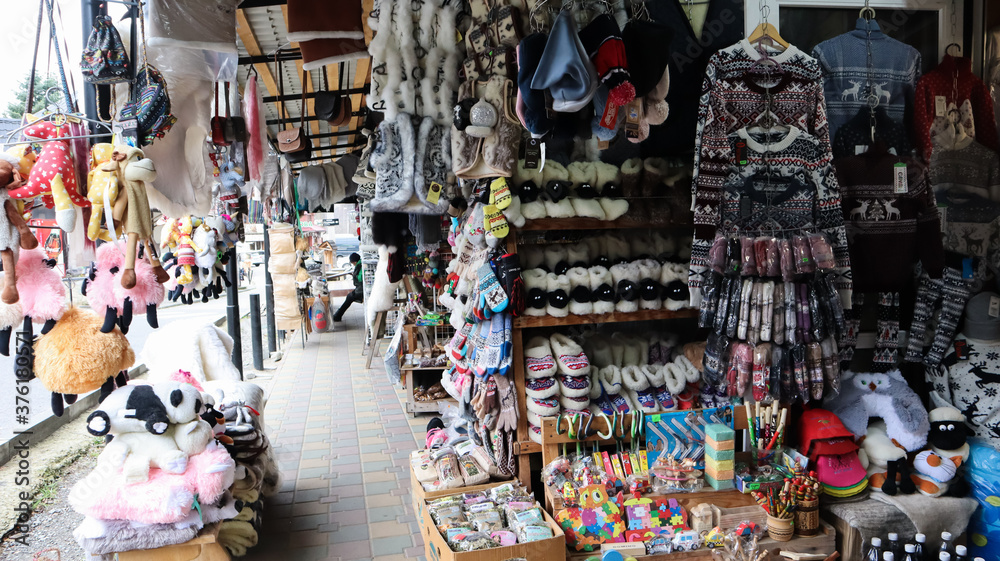 Souvenir market in Yaremche with traditional Carpathian handmade clothing, herbs and wooden tools. Ukrainian textiles, knitted socks, vests, hats. Souvenir market in Yaremche with traditional Carpathian handmade clothing, herbs and wooden tools. Ukrainian textiles, knitted socks, vests, hats.