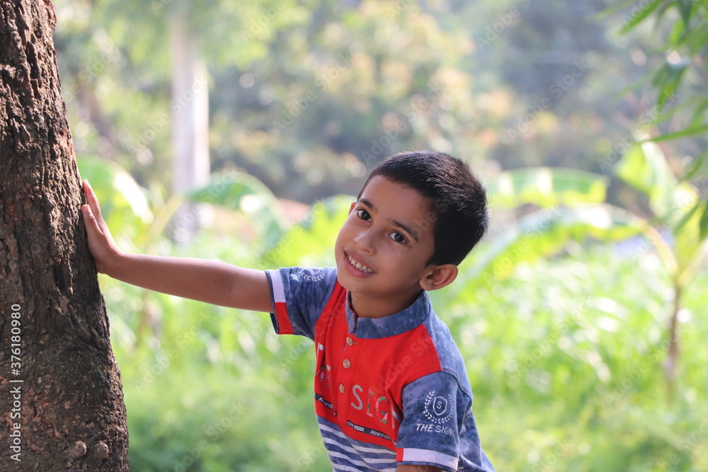 Cute little happy boy posing for photo on a summer day Cute little happy boy posing for photo on a summer day
