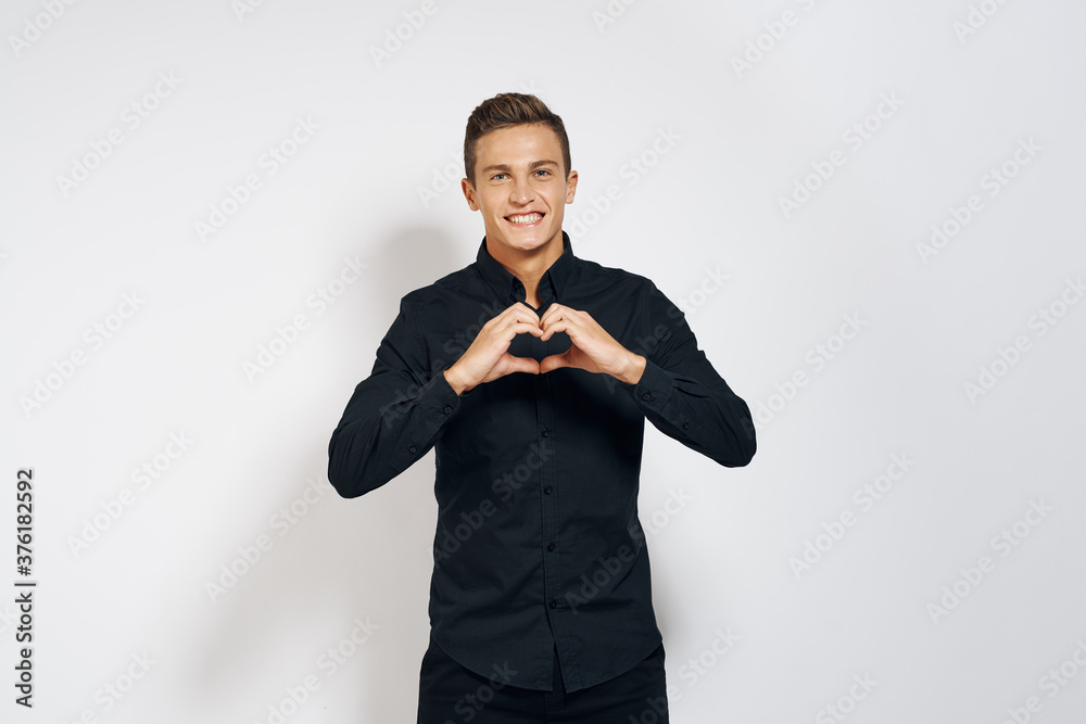 Man in black shirt lifestyle emotions modern style cropped view light background Man in black shirt lifestyle emotions modern style cropped view light background