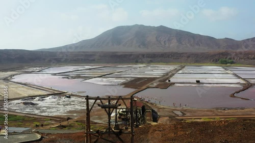 Aerial shot of the Pedra de Lume salt evaporation ponds, inside the crater of an extinct volcano. Camera rises up then tilts down to focus on the majestic salt ponds. Island of Sal, Cabo Verde. photo