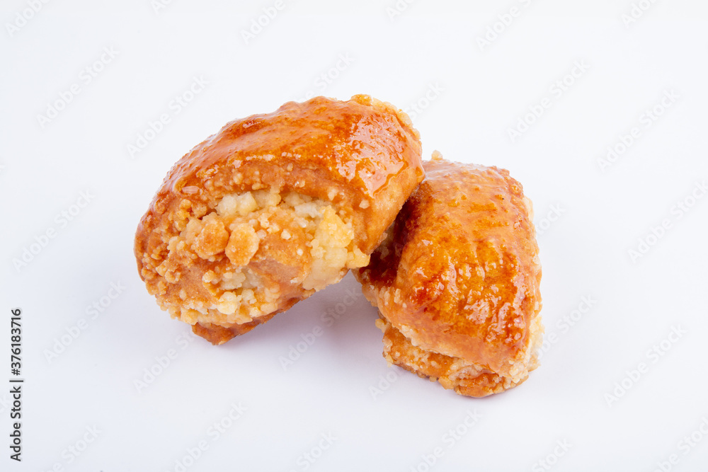 fresh sweet cookies in icing sugar for tea, isolated on a white background fresh sweet cookies in icing sugar for tea, isolated on a white background