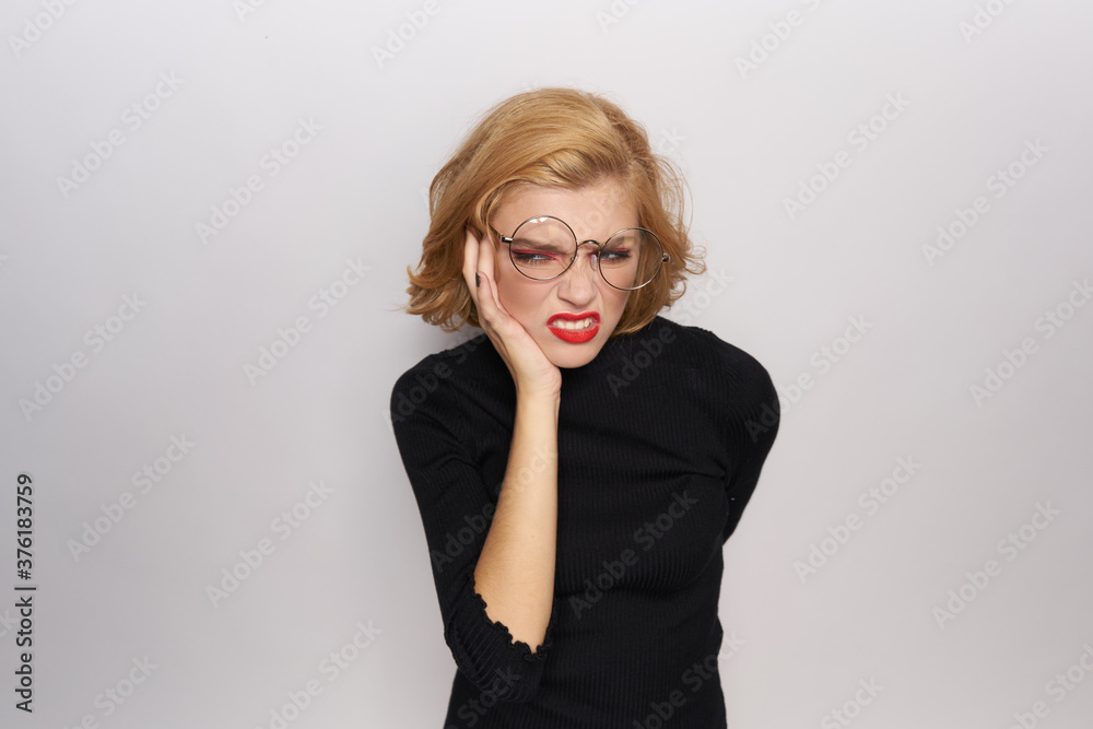 Cute blonde in glasses bright makeup black jacket cropped view light background emotions Cute blonde in glasses bright makeup black jacket cropped view light background emotions