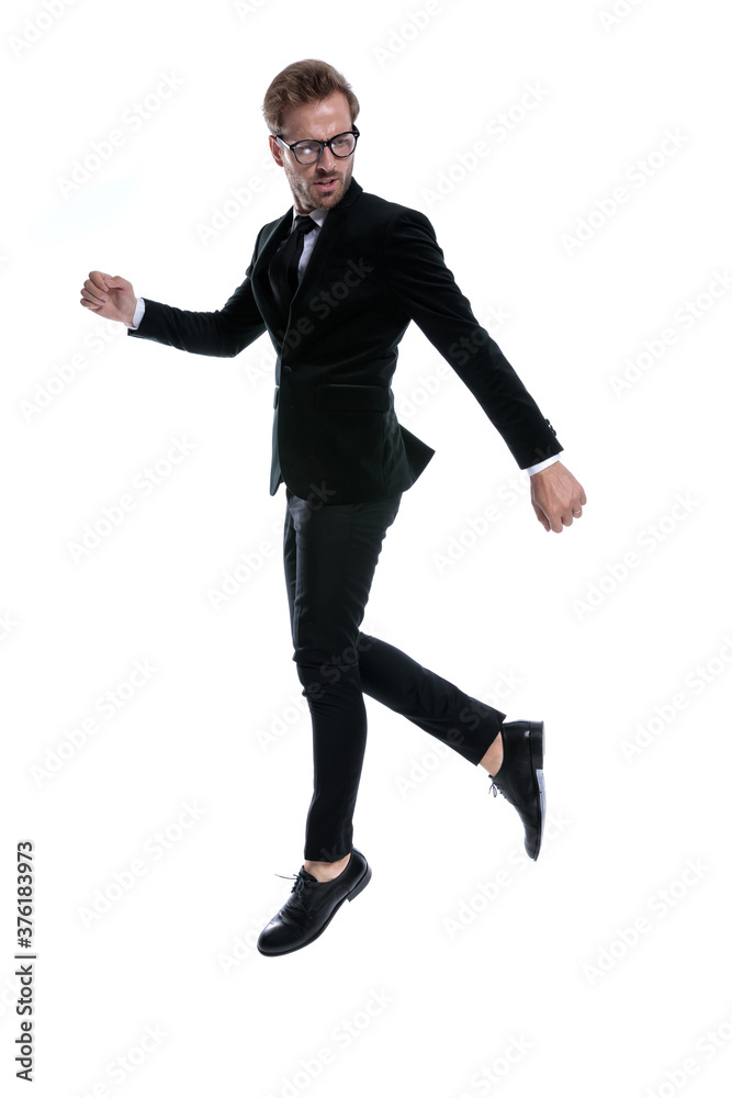 cool stylish man in black suit holding knee up