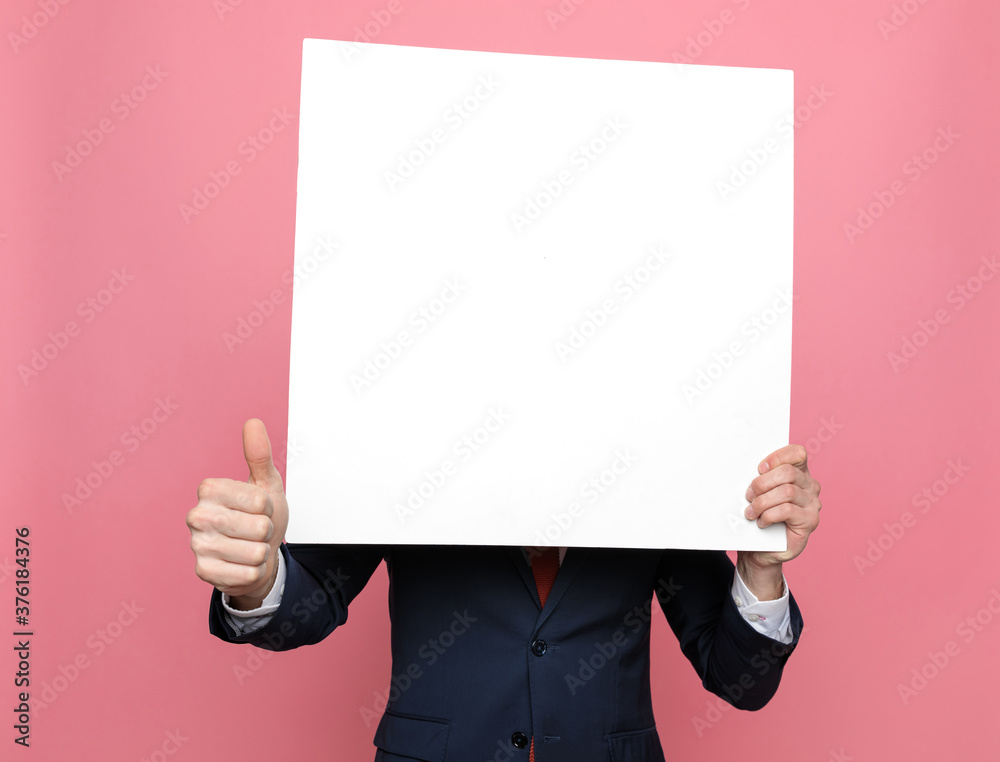 elegant businessman hiding behind white empty board elegant businessman hiding behind white empty board