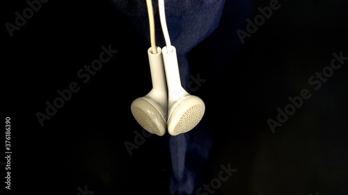 Earphone in black background  looking cool and relaxing in concept of listening music. 